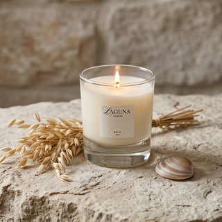 Panel 1: Lit Laguna “821-A” candle on a textured stone surface with dried wheat stalks and a seashell.