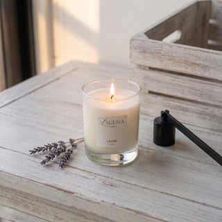 Panel 1: Lit Laguna “Layne” candle on a whitewashed table with dried lavender and candle tools.